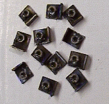 A dozen cladding mounting tabs